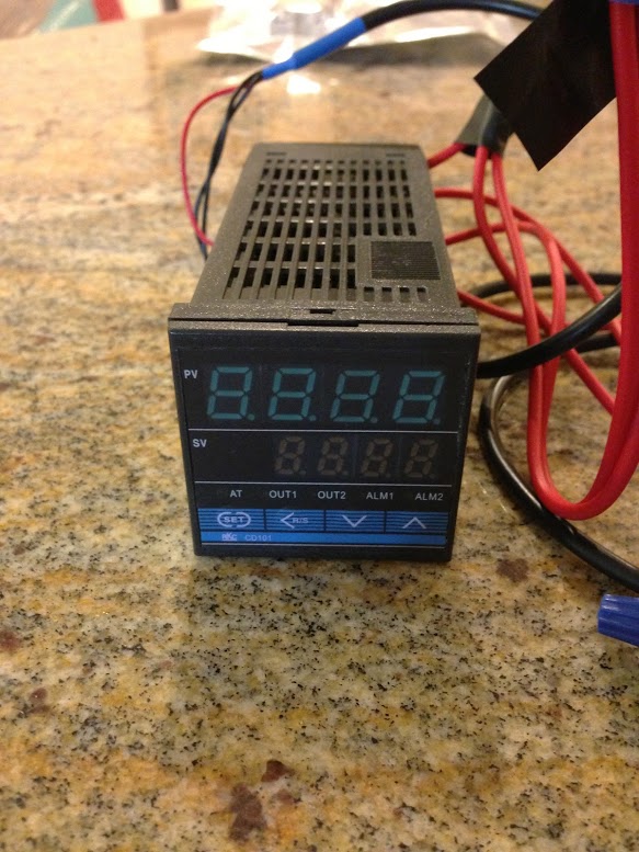 The heart of the setup. The PID takes temperature information from the thermocouple and sends a signal to a relay to complete/break a circuit based on temperature. This model has its own electrical relay built-in. Somehow, Seattle Food Geek blog had a PID with an internal relay that could take three immersion heaters. Based on the electrical rating on mine... it can take basically one. The heart of the setup. The PID takes temperature information from the thermocouple and sends a signal to a relay to complete/break a circuit based on temperature. This model has its own electrical relay built-in. Somehow, Seattle Food Geek blog had a PID with an internal relay that could take three immersion heaters. Based on the electrical rating on mine... it can take basically one.